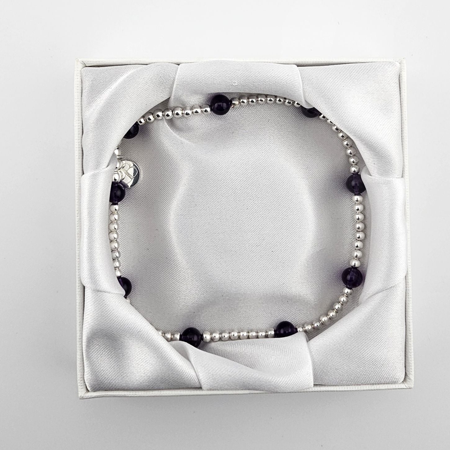 Bessie Bae sterling silver anklet with dark gemstone beads presented in a white gift box.