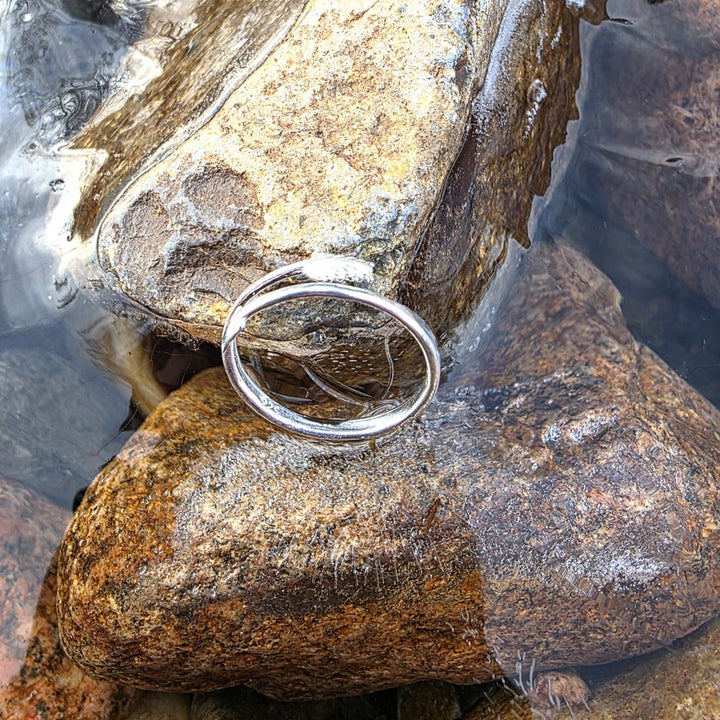 Handcrafted sterling silver ring styled on natural rocks in a flowing stream by Bessie Bae.