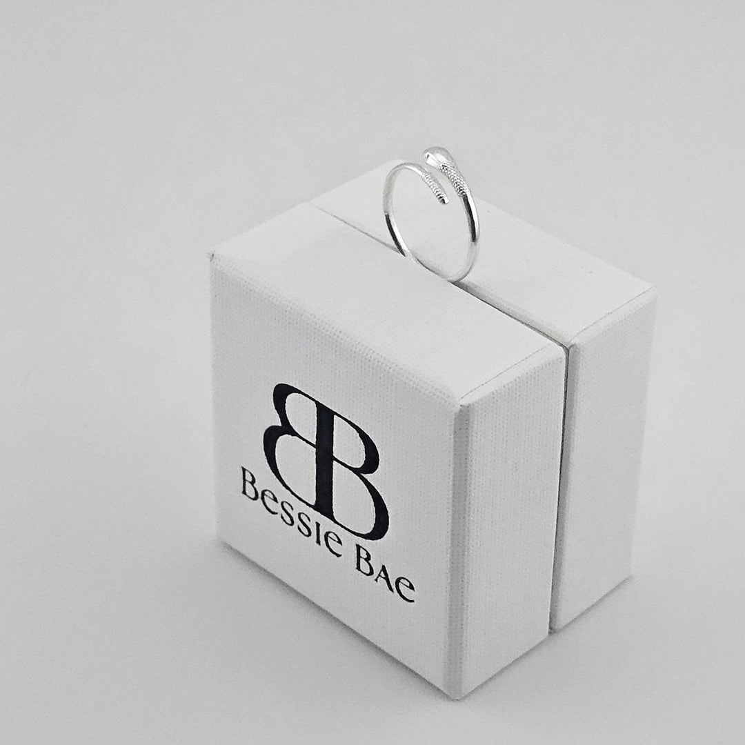 Open band silver snake ring for women.