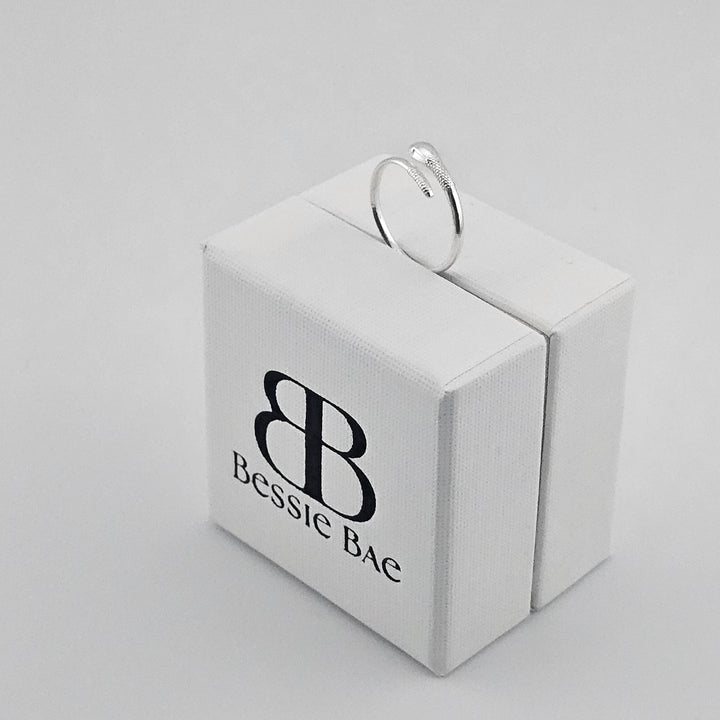 Open band silver snake ring for women.