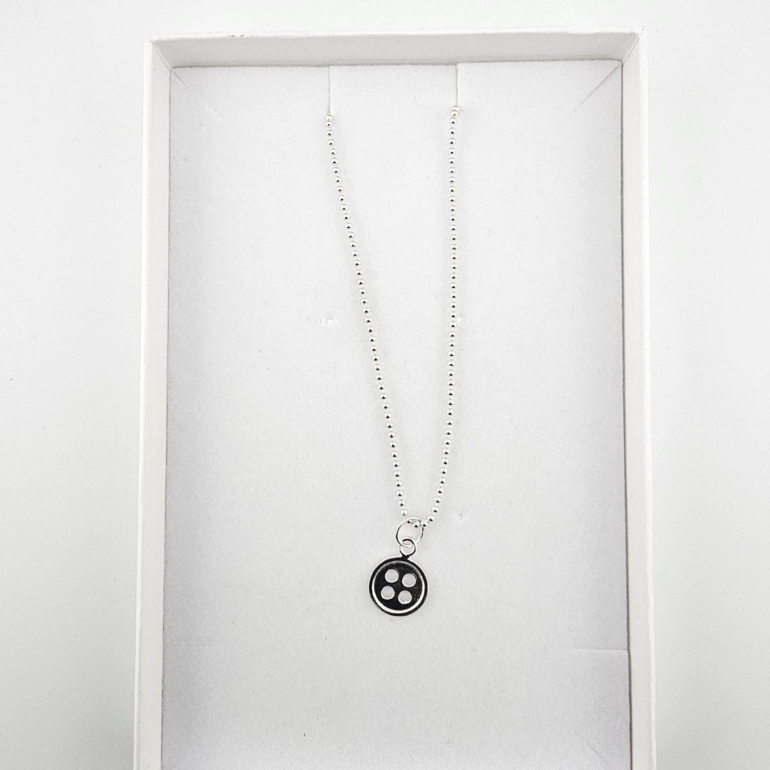 Sterling silver button charm necklace presented in Bessie Bae gift box.