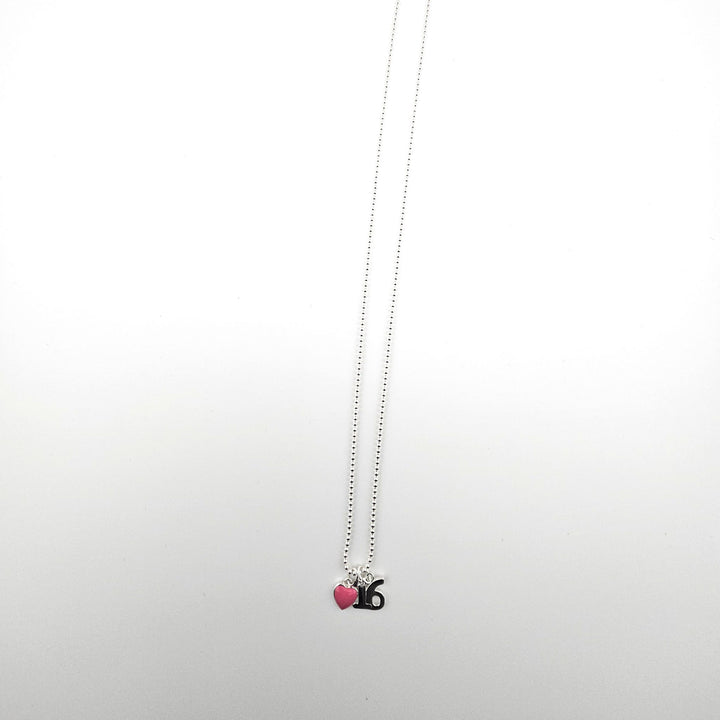 Sterling silver 16th birthday necklace with pink heart charm on a light background.