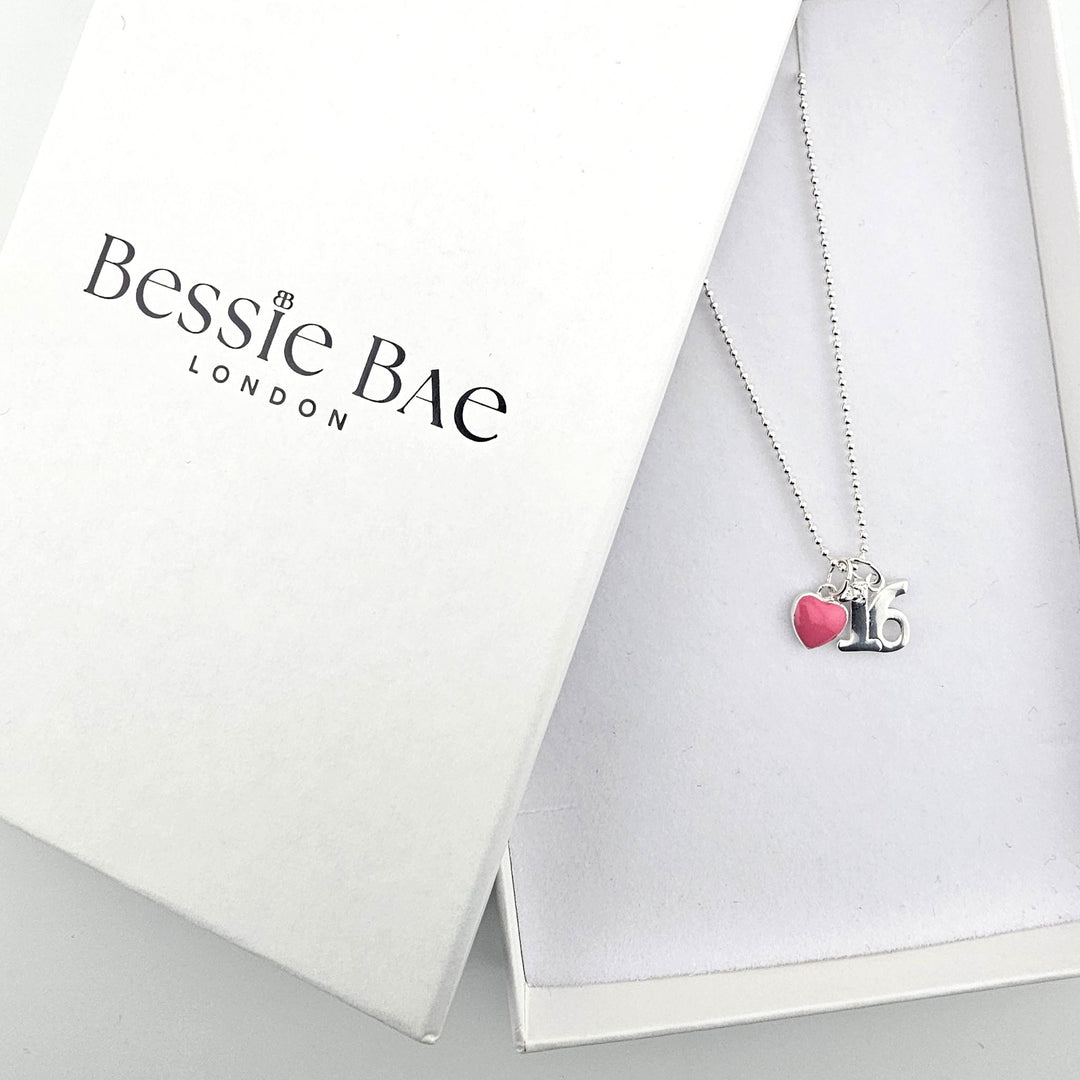 Sterling silver 16th birthday heart necklace shown beside Bessie Bae branded packaging.
