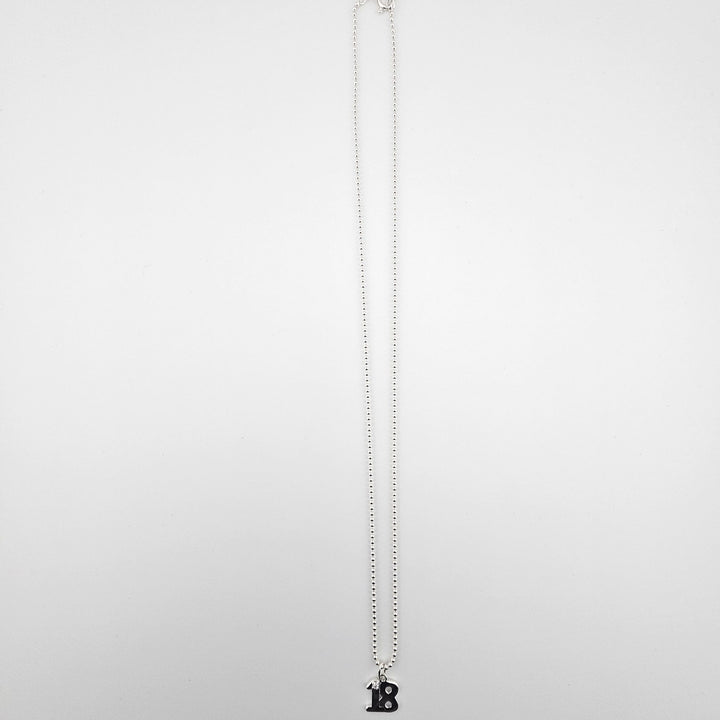 Sterling silver 18th birthday necklace with ball chain displayed on a light background.