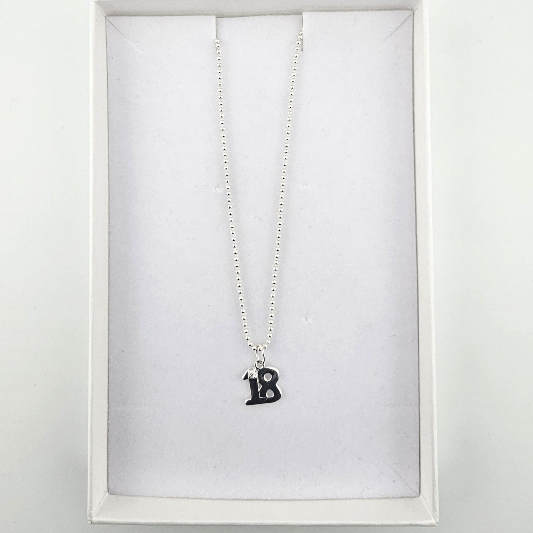 Sterling silver 18th birthday necklace presented inside a white jewellery gift box.