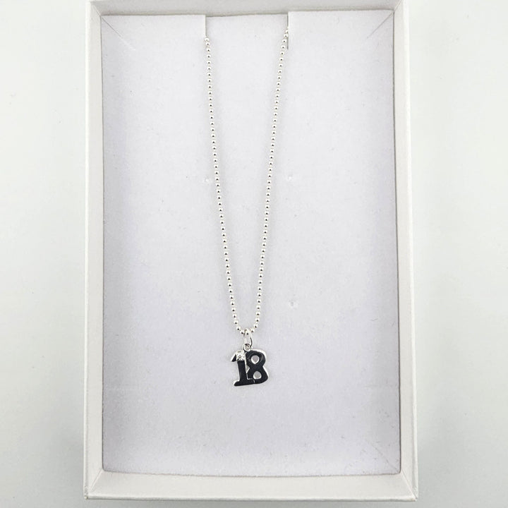 Sterling silver 18th birthday necklace presented inside a white jewellery gift box.