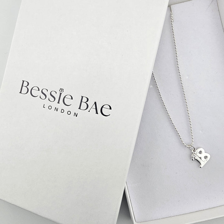 Sterling silver 18 milestone necklace displayed beside Bessie Bae branded gift box.