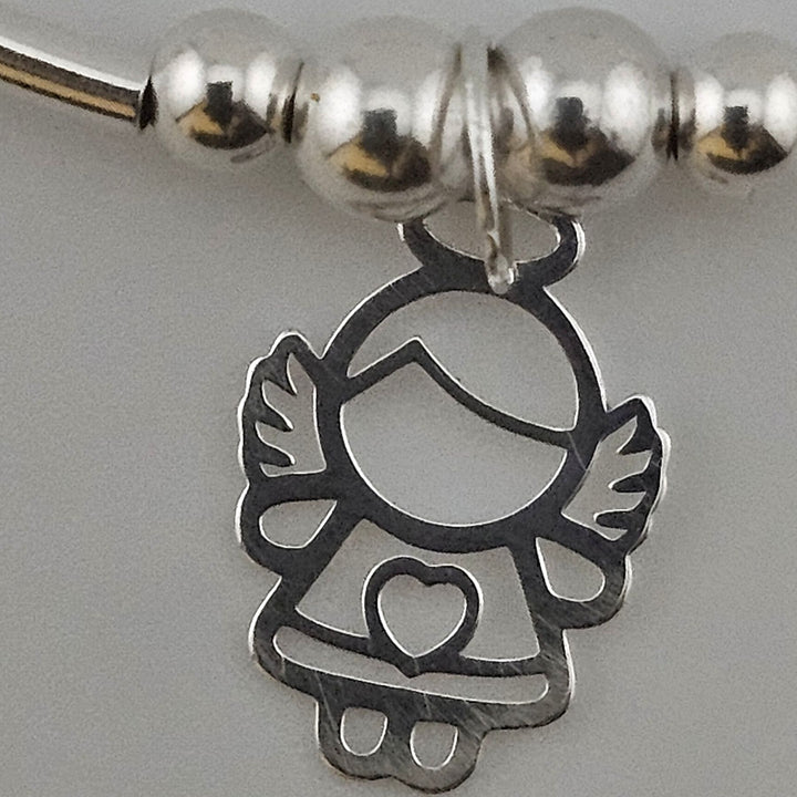 Close-up of sterling silver angel charm with heart.