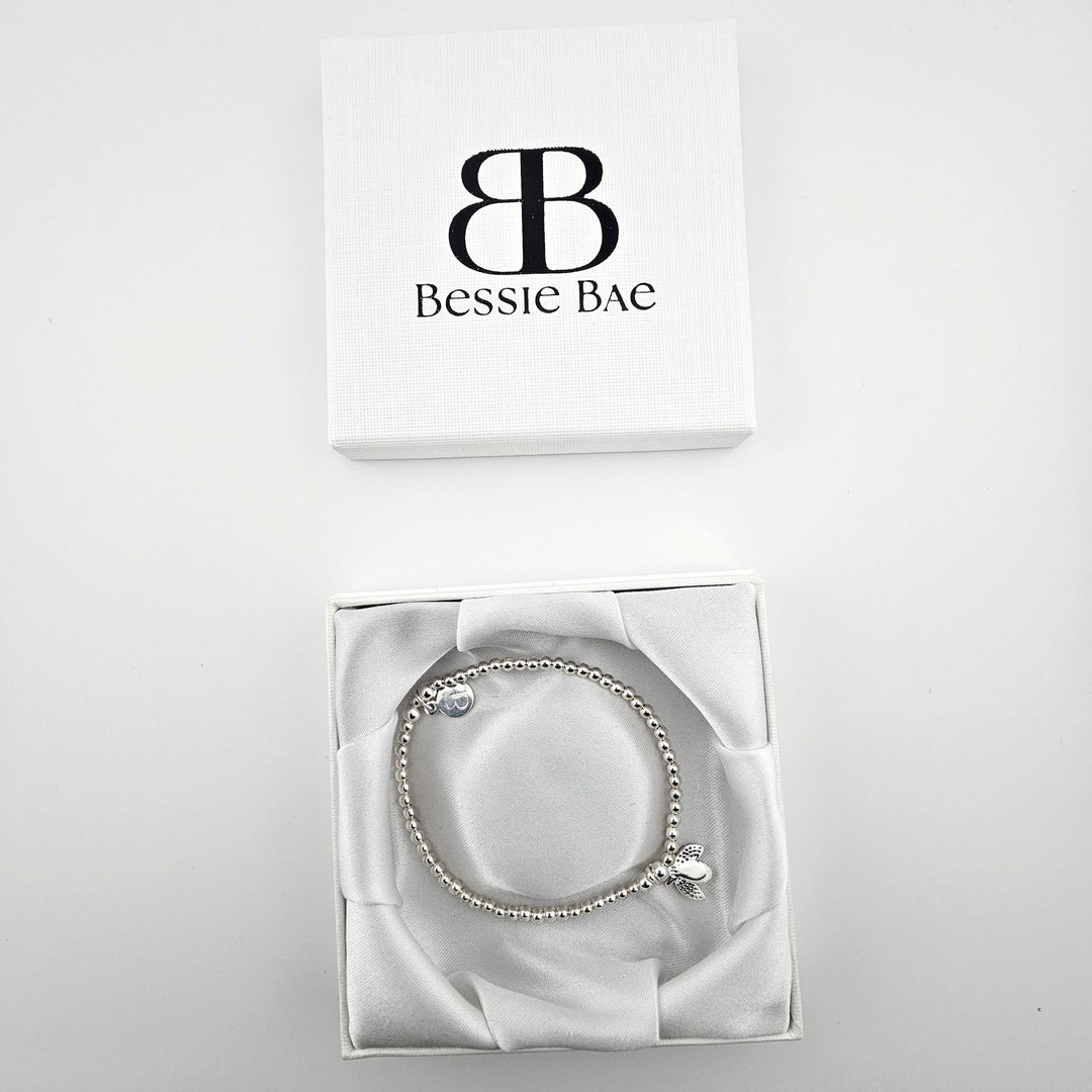 Bee charm sterling silver bracelet in white gift box.