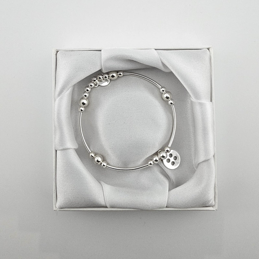 Bessie Bae packaging with Sterling Silver Button charm bracelet.