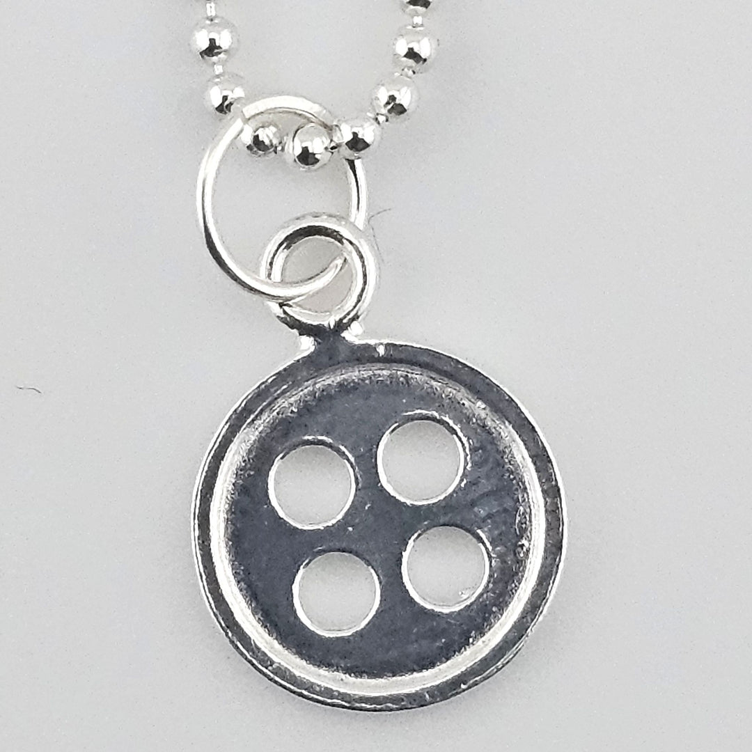 Close-up of 12mm button charm in 925 sterling silver.