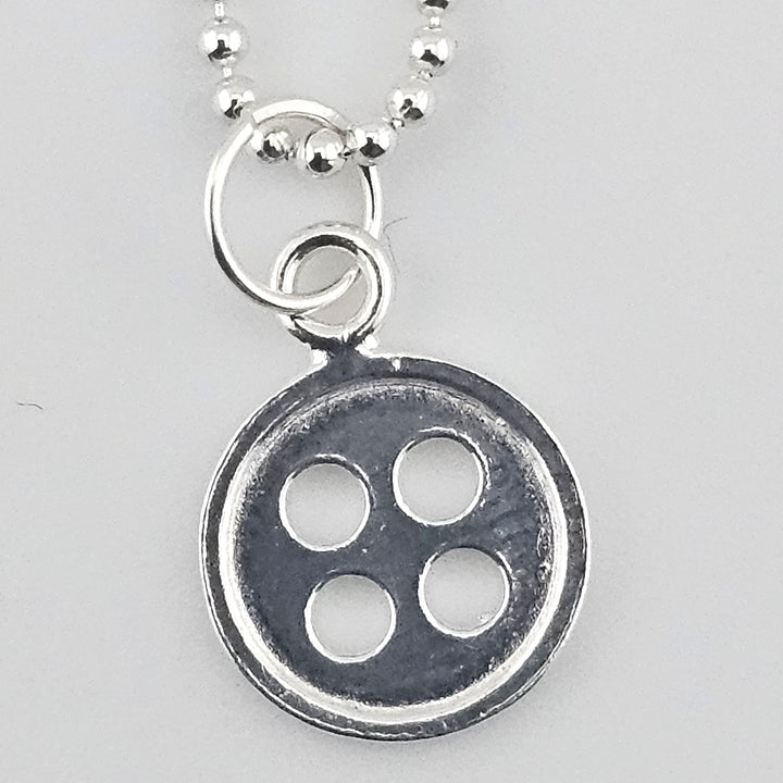 Close-up of 12mm button charm in 925 sterling silver.