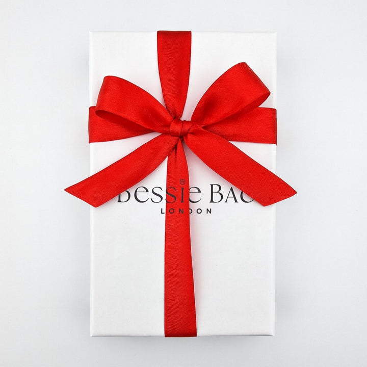 Bessie Bae white gift box with red satin ribbon, perfect for Christmas gifting.