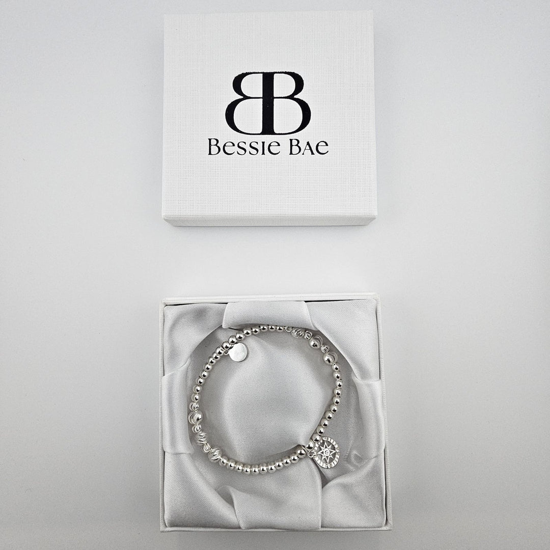 Bessie Bae compass bracelet with box and packaging.