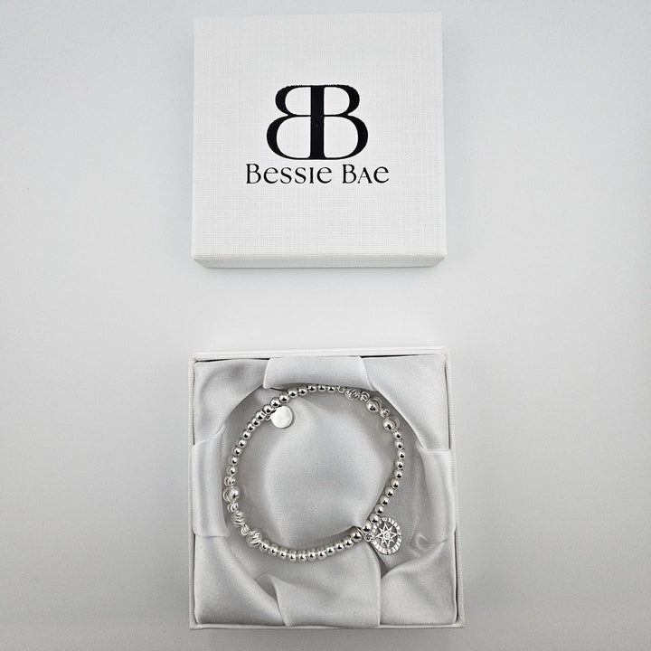 Bessie Bae compass bracelet with box and packaging.