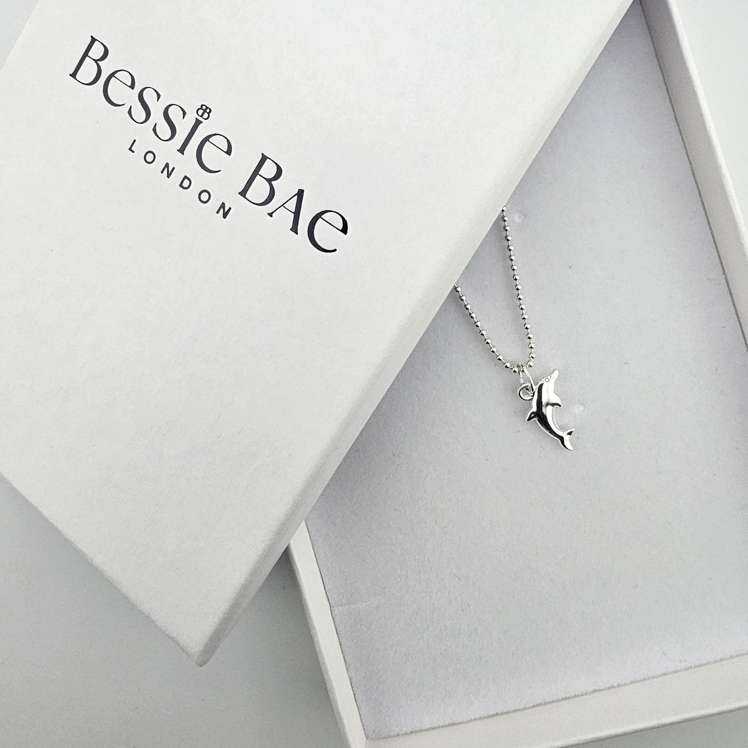 Sterling silver dolphin necklace presented in a Bessie Bae gift box.