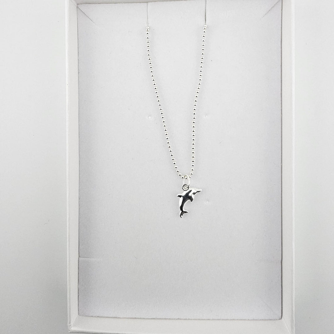 Bessie Bae dolphin necklace with branded luxury packaging.