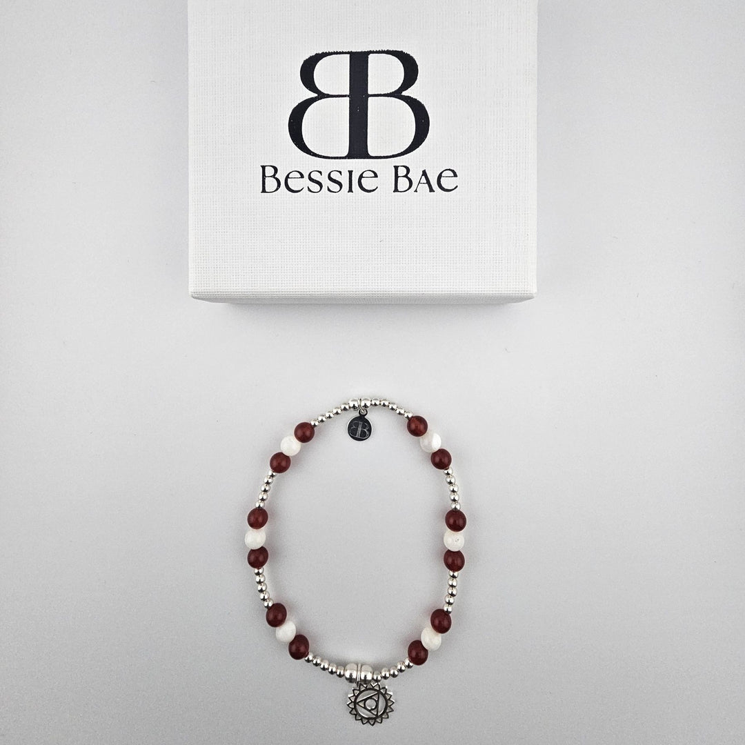 Flatlay of Garnet and Mother of Pearl sterling silver anklet.