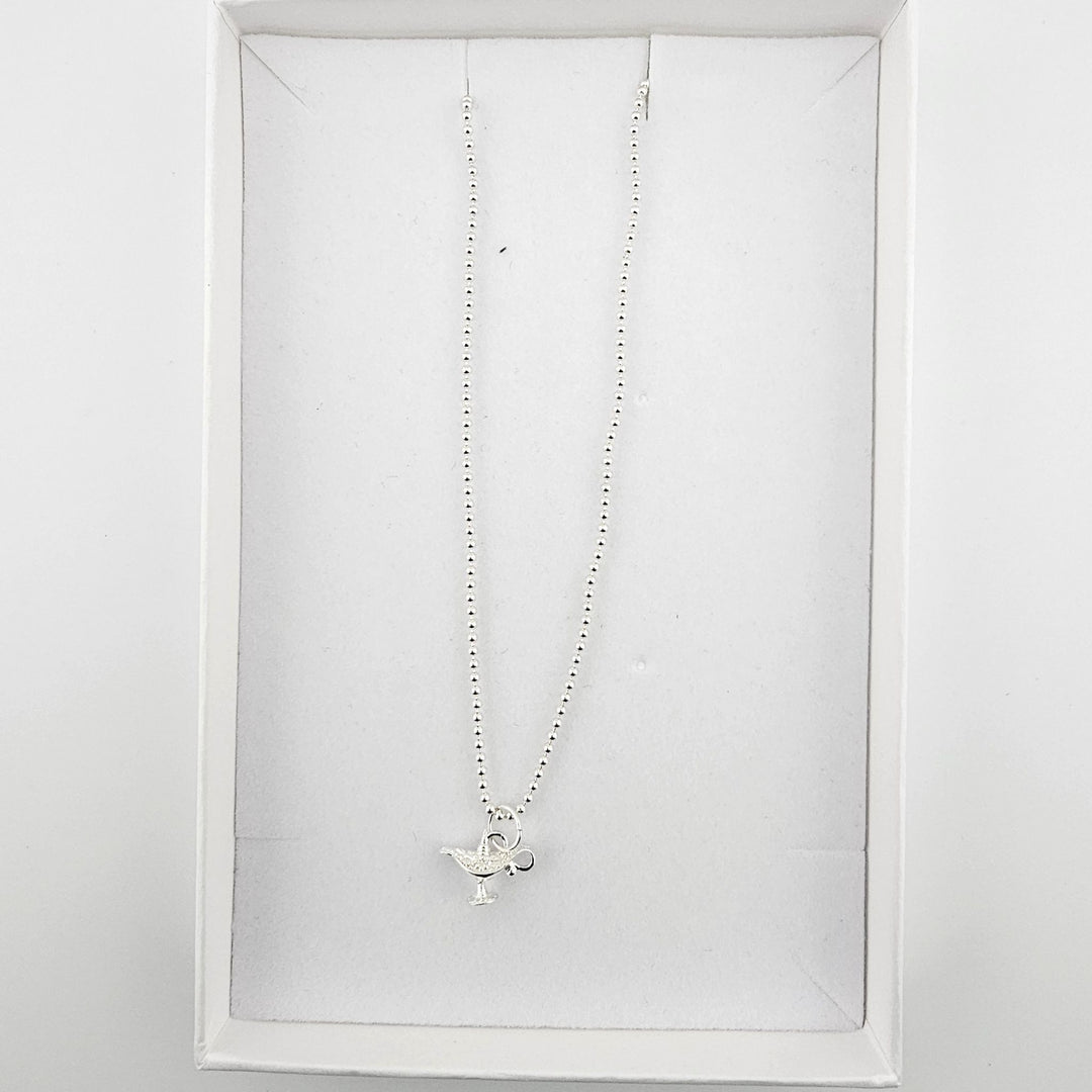Bessie Bae London genie’s lamp necklace with branded packaging.