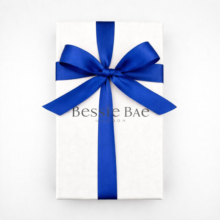 White Bessie Bae jewellery gift box finished with a royal blue satin ribbon, complimentary gift packaging.