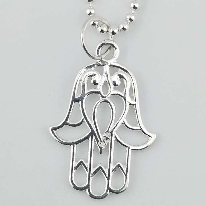22mm open Hamsa charm in 925 sterling silver with detailed cut-out design.