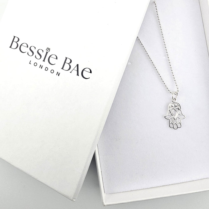 Bessie Bae sterling silver Hamsa charm necklace with complimentary gift packaging.