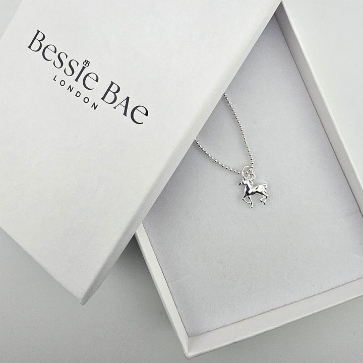 Bessie Bae horse necklace shown with branded luxury packaging.