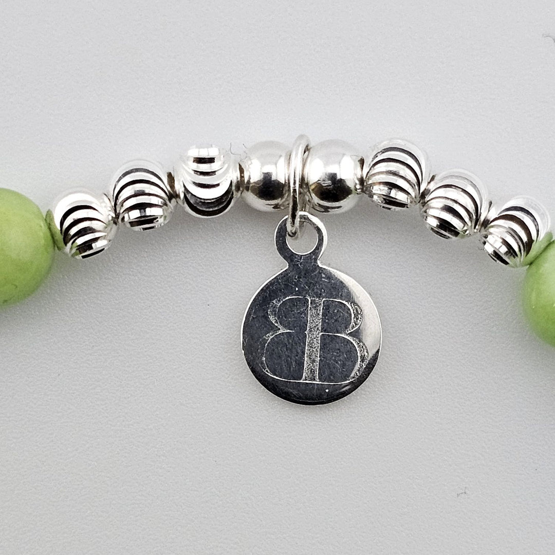 Bessie Bae logo tag on green aventurine bracelet.
