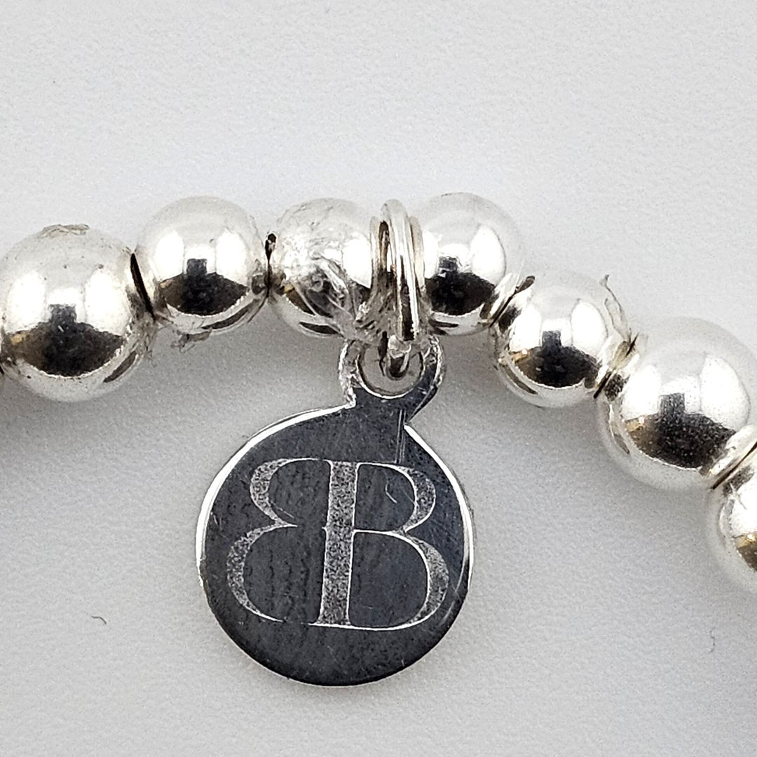 Bessie Bae logo tag on sterling silver bracelet.