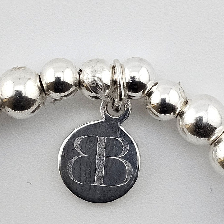 Bessie Bae logo tag on sterling silver bracelet.