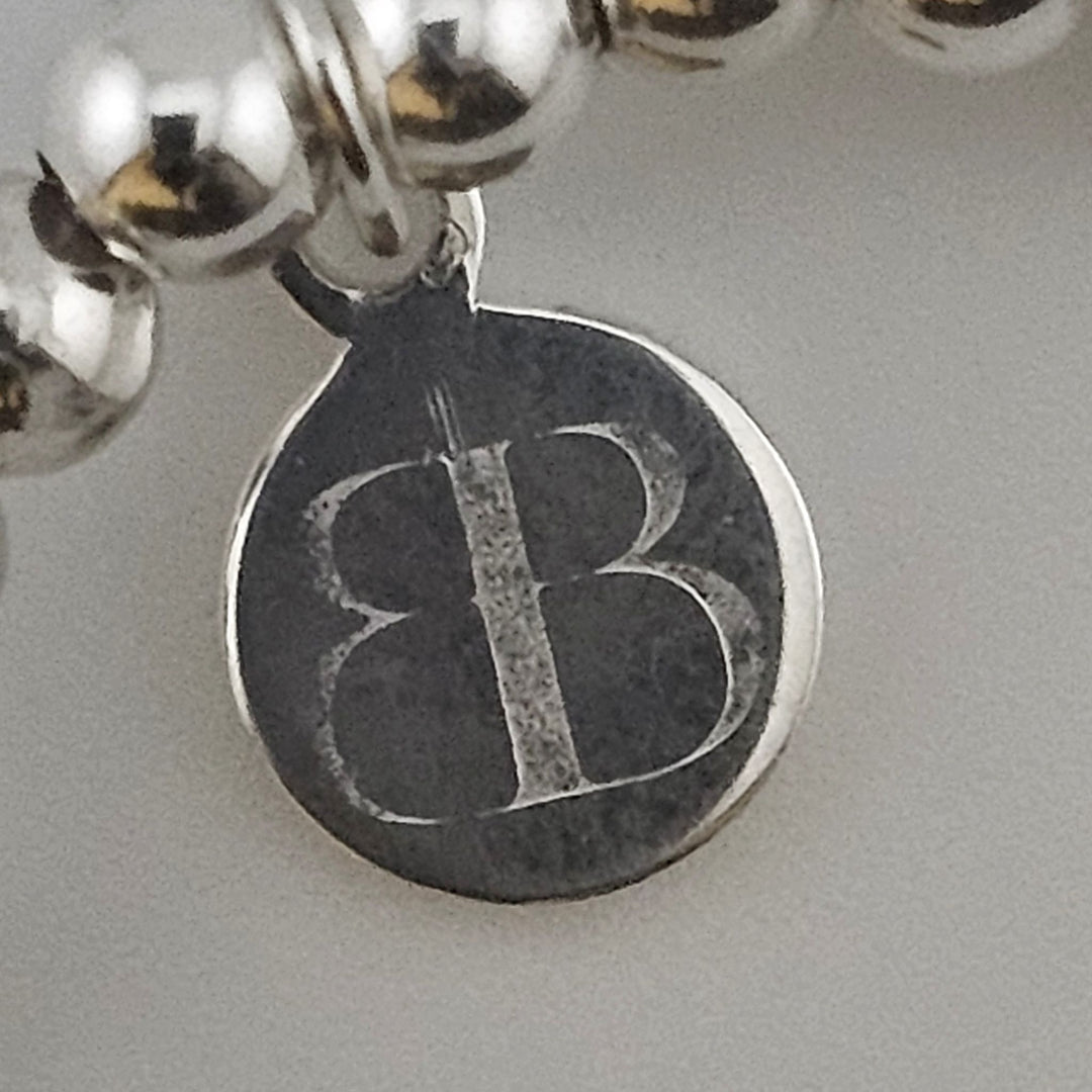 Bessie Bae logo tag on handcrafted Sterling Silver Button Bracelet.