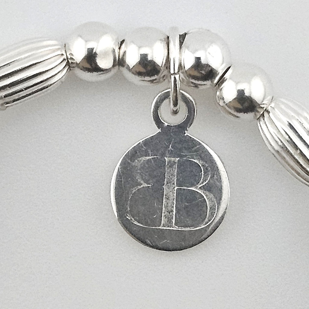 Bessie Bae signature logo tag on Sterling Silver and gemstone bracelet.