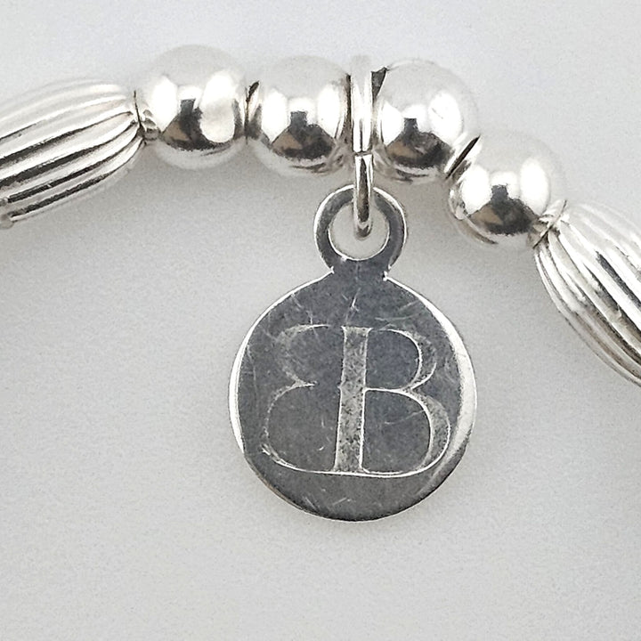 Bessie Bae signature logo tag on Sterling Silver and gemstone bracelet.