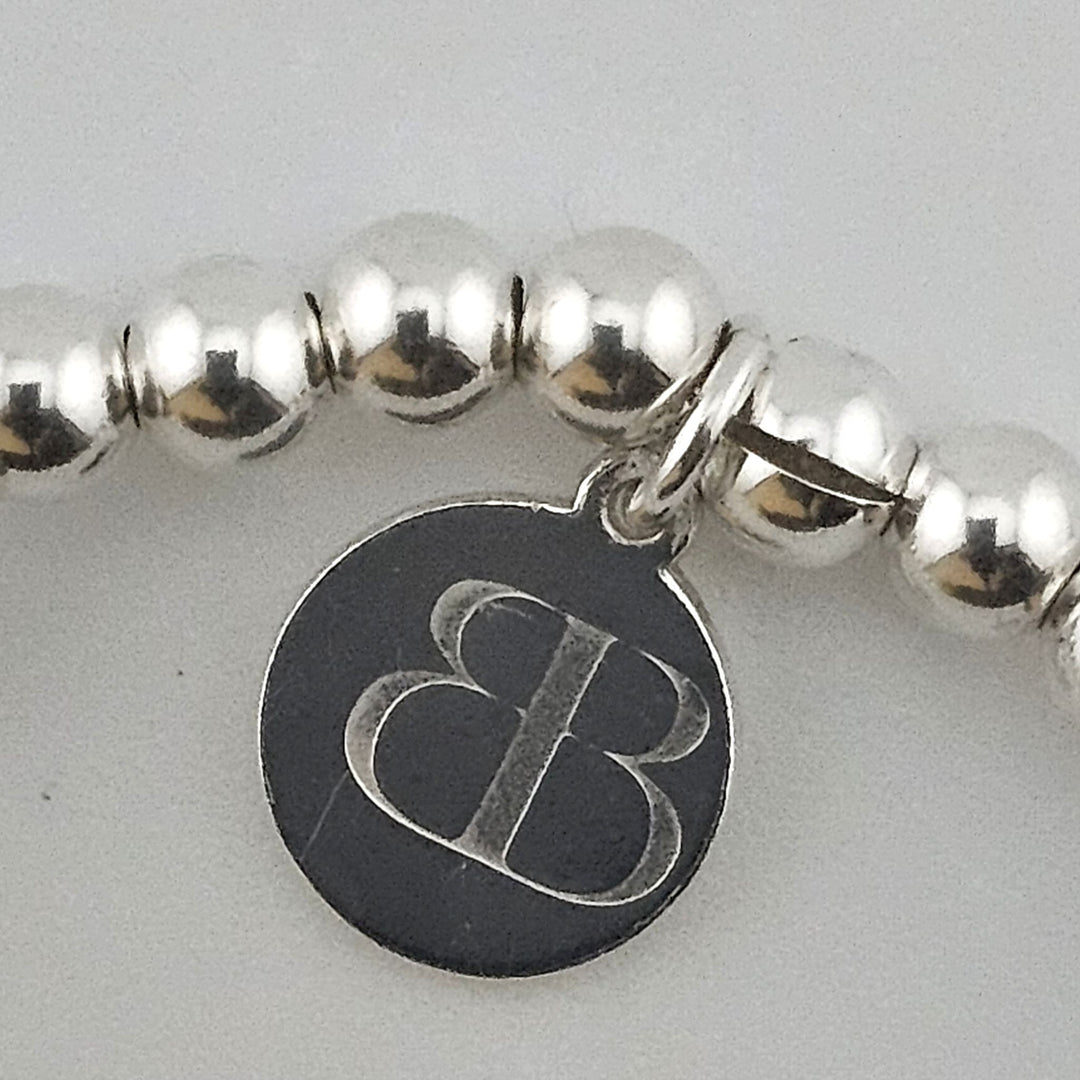 Bessie Bae logo tag on Sterling Silver Sun and Moon Bracelet.