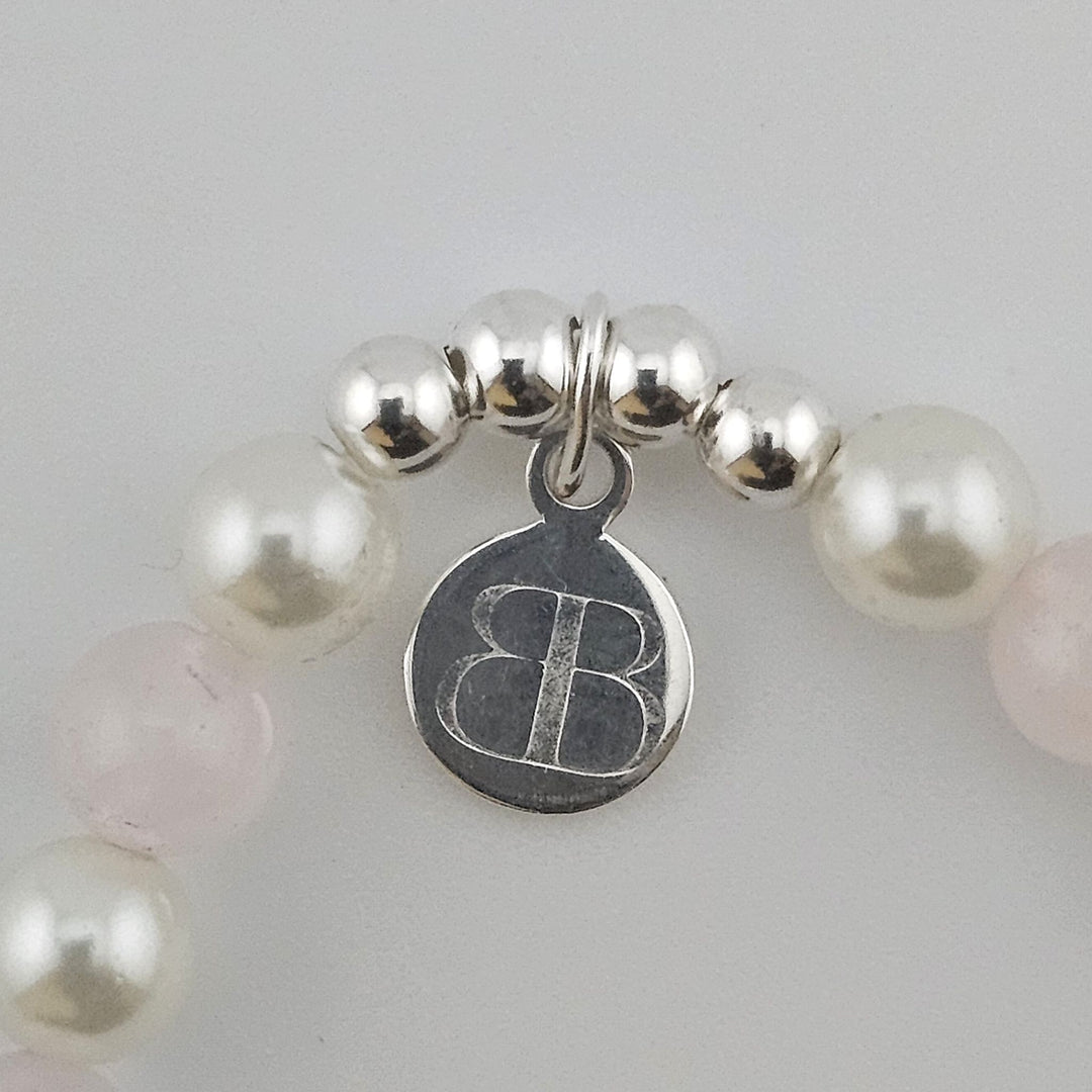 Bessie Bae logo tag on Sterling Silver Rose Quartz Teddy Bear bracelet.