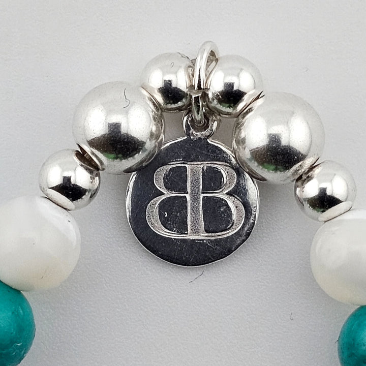 Close-up of Bessie Bae logo charm on Sterling Silver bracelet.