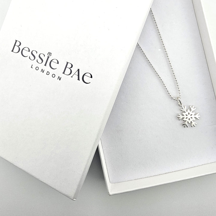 Bessie Bae London packaging with sterling silver snowflake necklace.