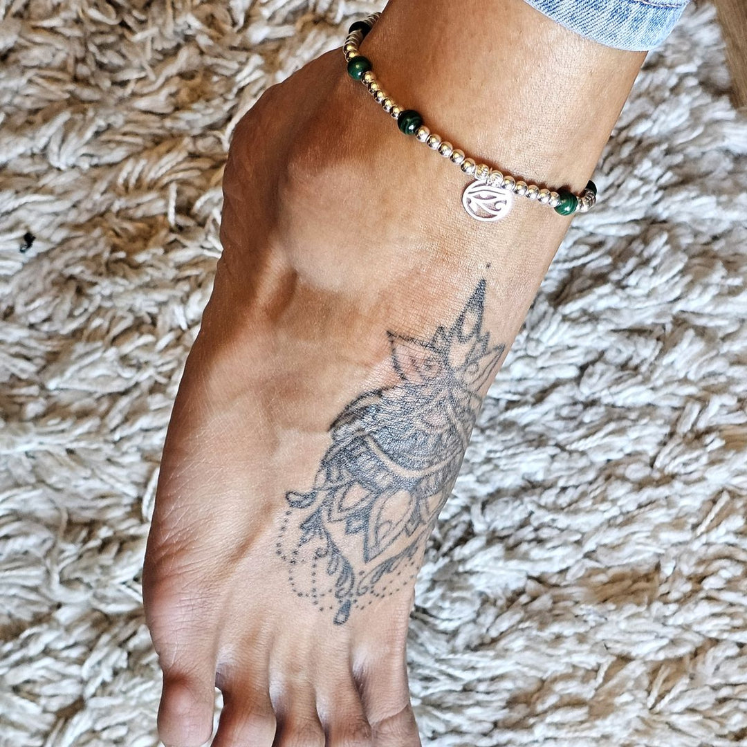 Malachite and sterling silver anklet worn on an ankle with a mandala tattoo.