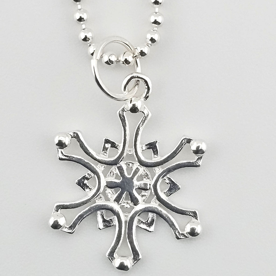 Close-up of 925 sterling silver Nordic star charm on necklace.