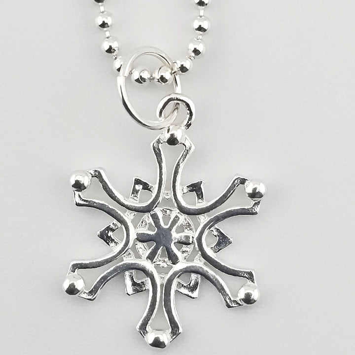 Close-up of 925 sterling silver Nordic star charm on necklace.