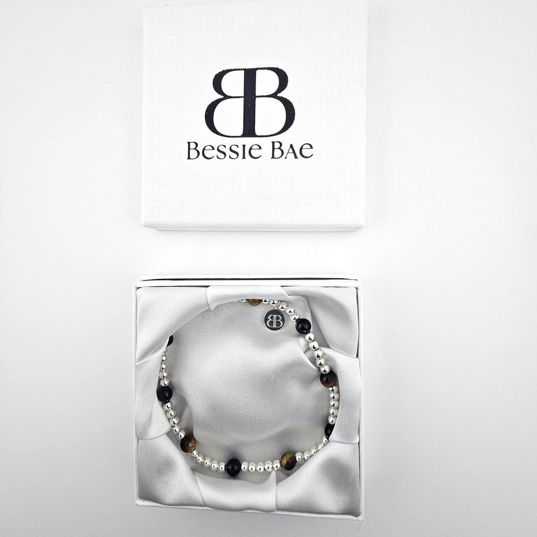 Bessie Bae Sterling Silver Onyx and Tiger’s Eye Anklet presented in a white branded gift box.