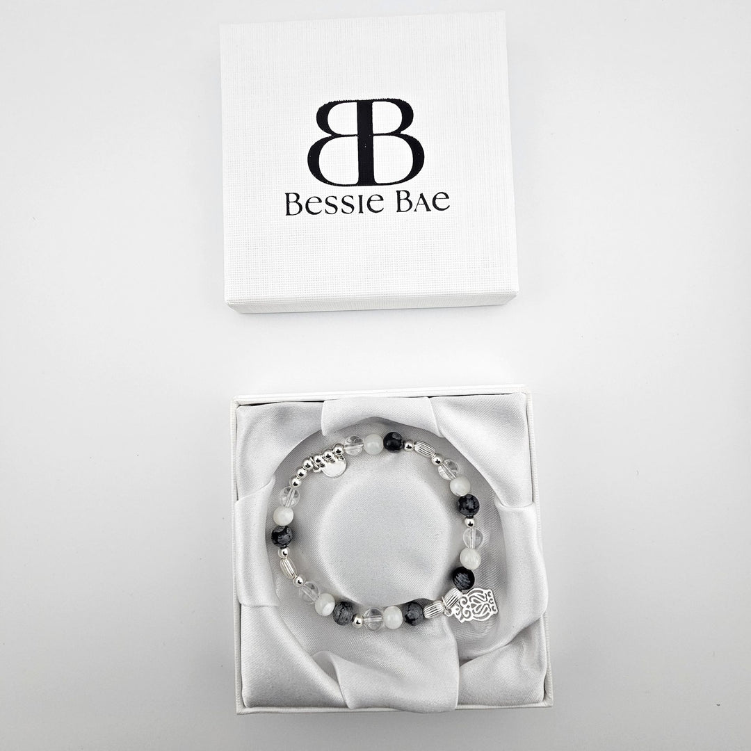 Owl charm sterling silver bracelet in white satin gift box.