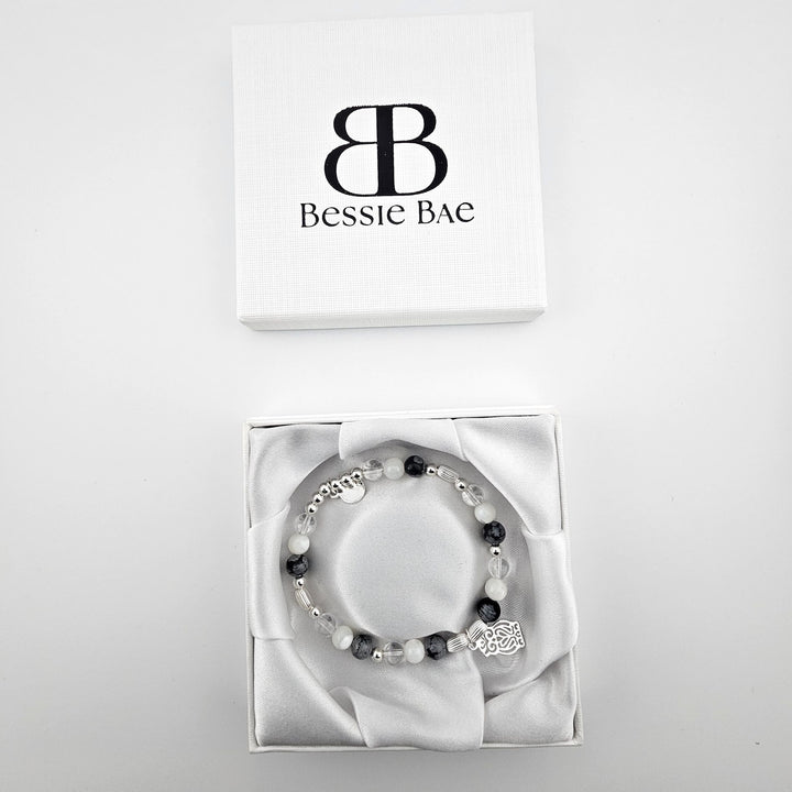 Owl charm sterling silver bracelet in white satin gift box.