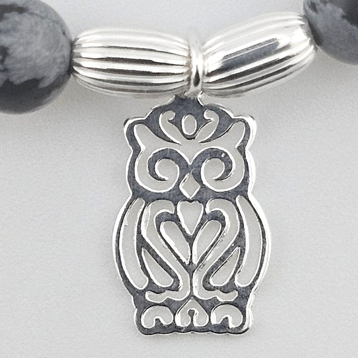 Close-up of owl charm in sterling silver.