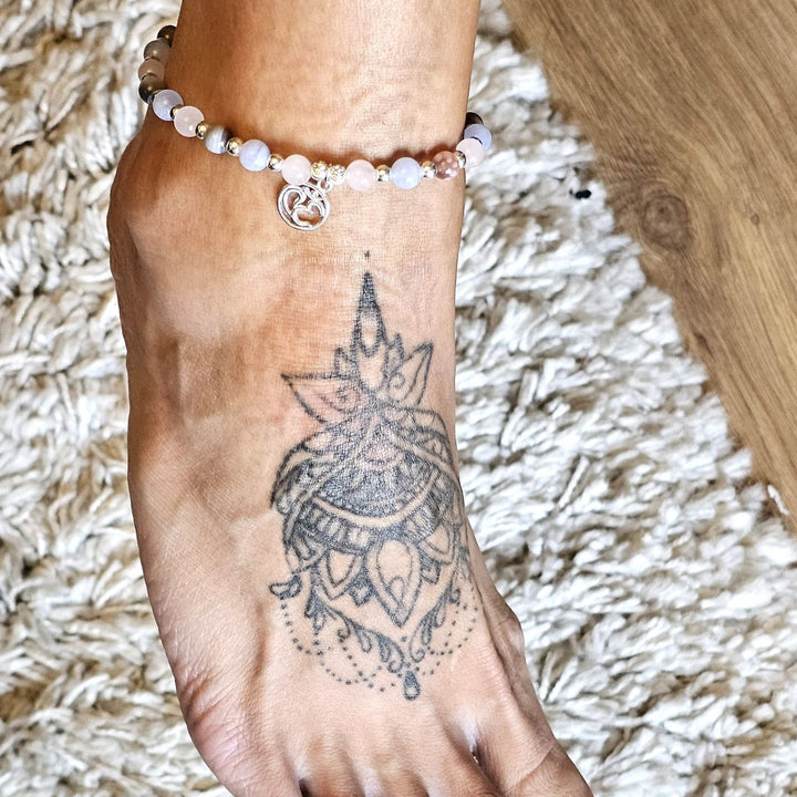 Pastel semi-precious stone and sterling silver anklet worn on an ankle with a mandala tattoo.