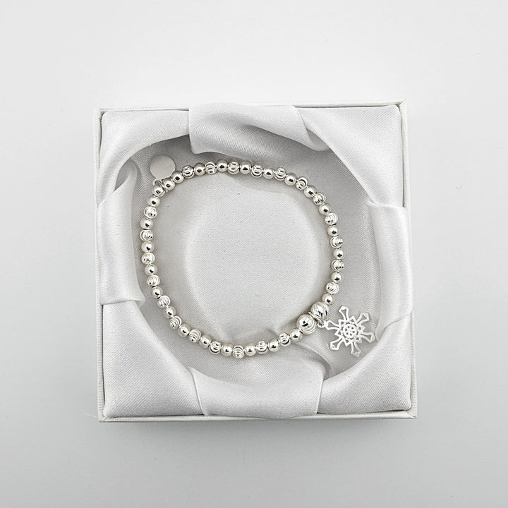 Bessie Bae snowflake bracelet with packaging.