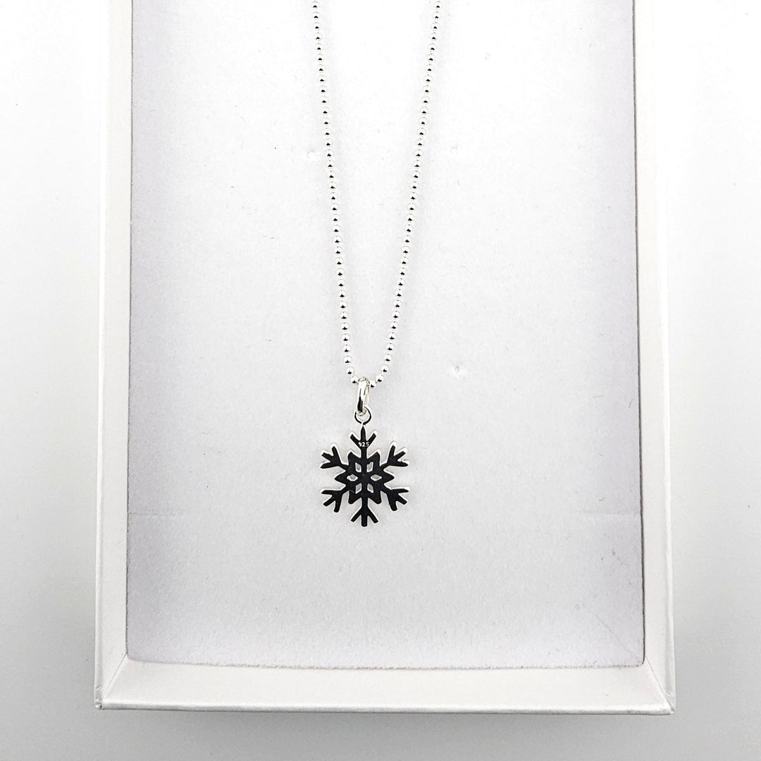 Sterling silver snowflake necklace presented in Bessie Bae London gift box.