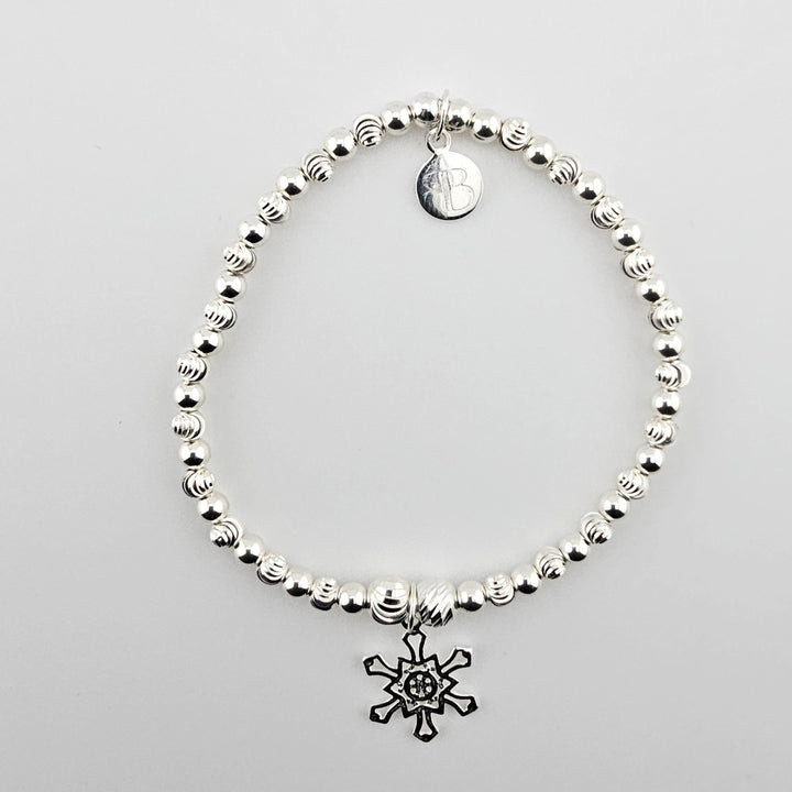 Sterling silver bracelet with snowflake charm.