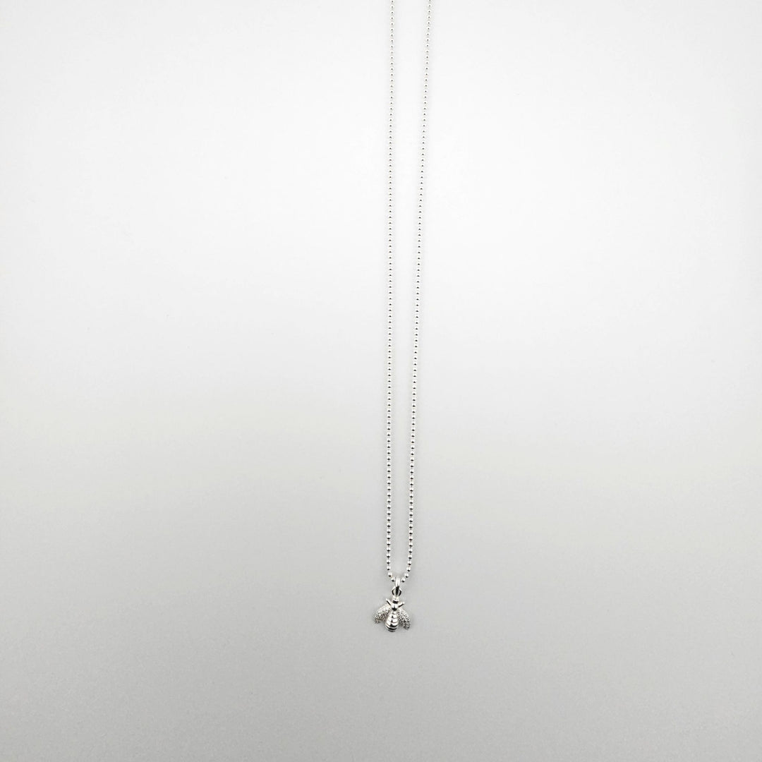 Sterling silver bee pendant necklace on fine ball chain.