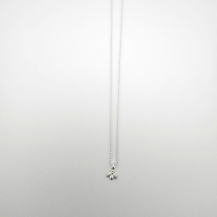 Sterling silver bee pendant necklace on fine ball chain.